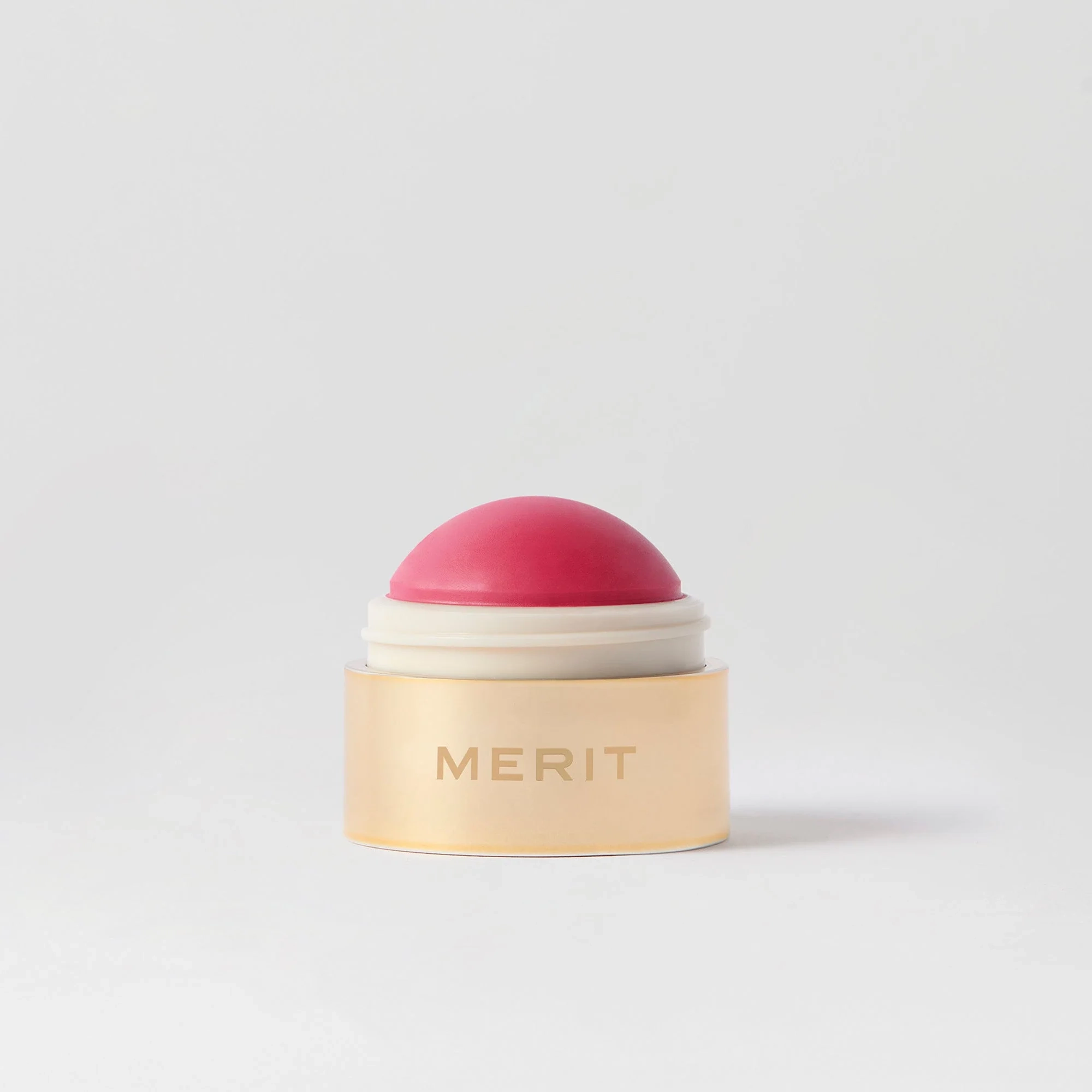 Flush Balm in Le Bonbon, a pink cream blush in a gold-rimmed pot