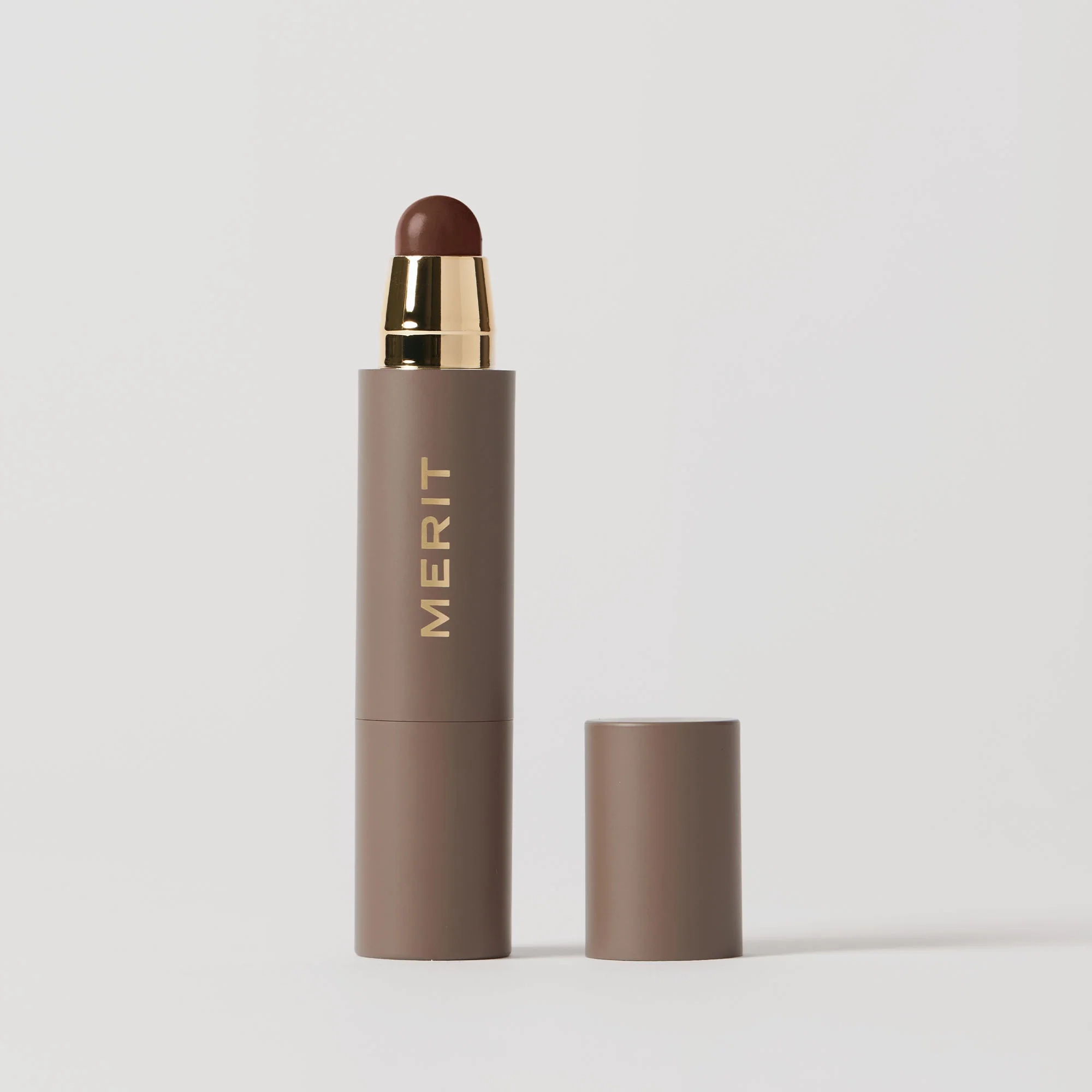 The Minimalist stick with its cap removed, shown in shade Bistre
