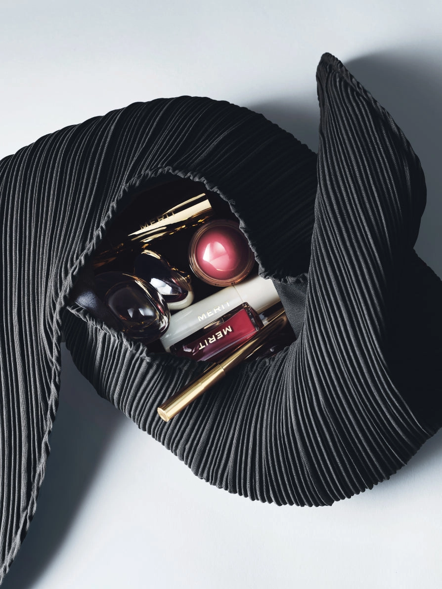 The Signature Bag from above with lipsticks and a blush spilling out