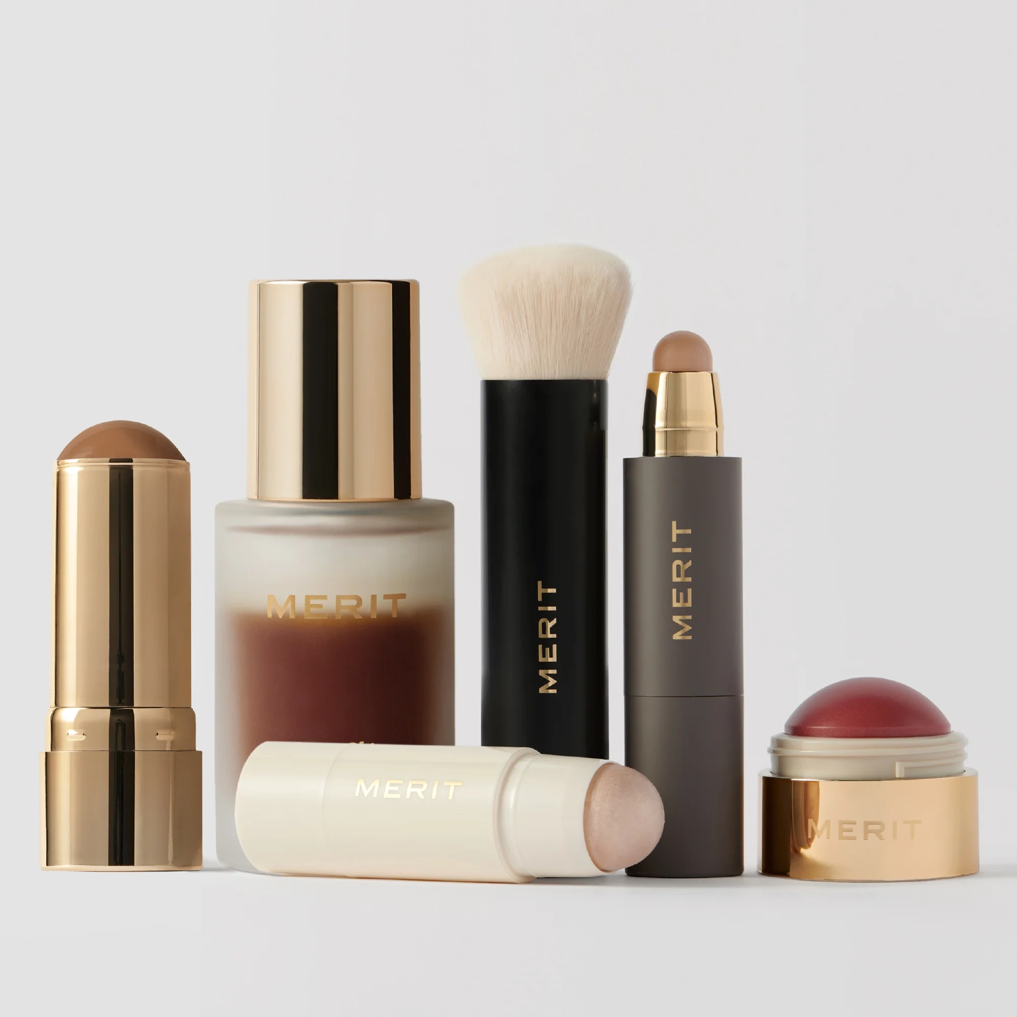 The Complexion Set laid out with brush, sticks and balms