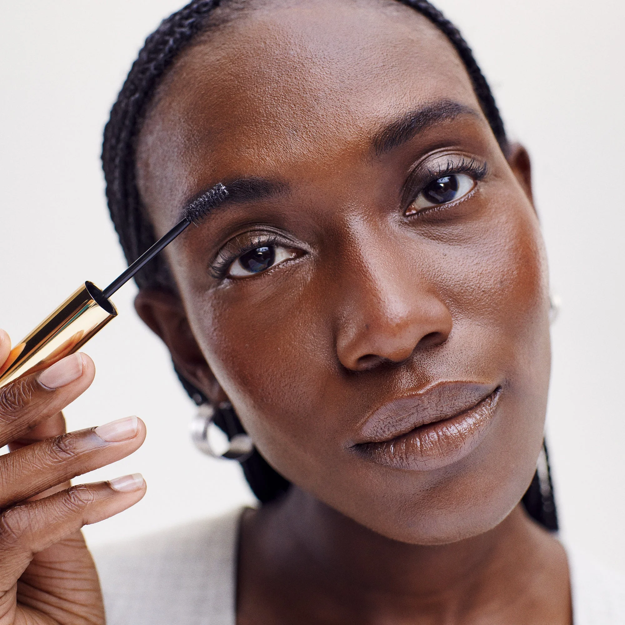 Model brushing Brow 1980 onto an eyebrow